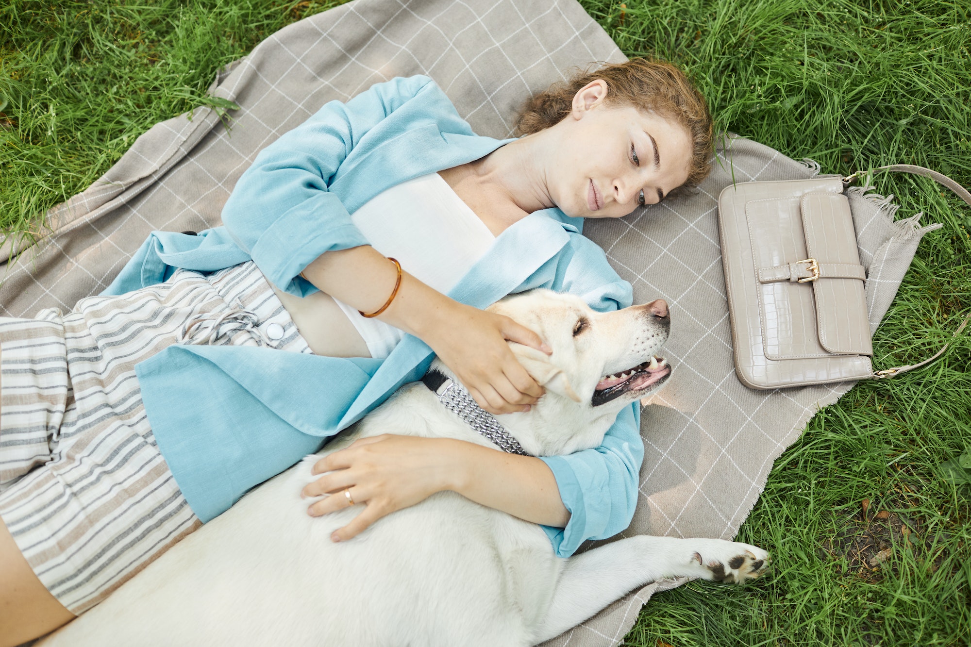 Woman Enjoying Picnic with Dog